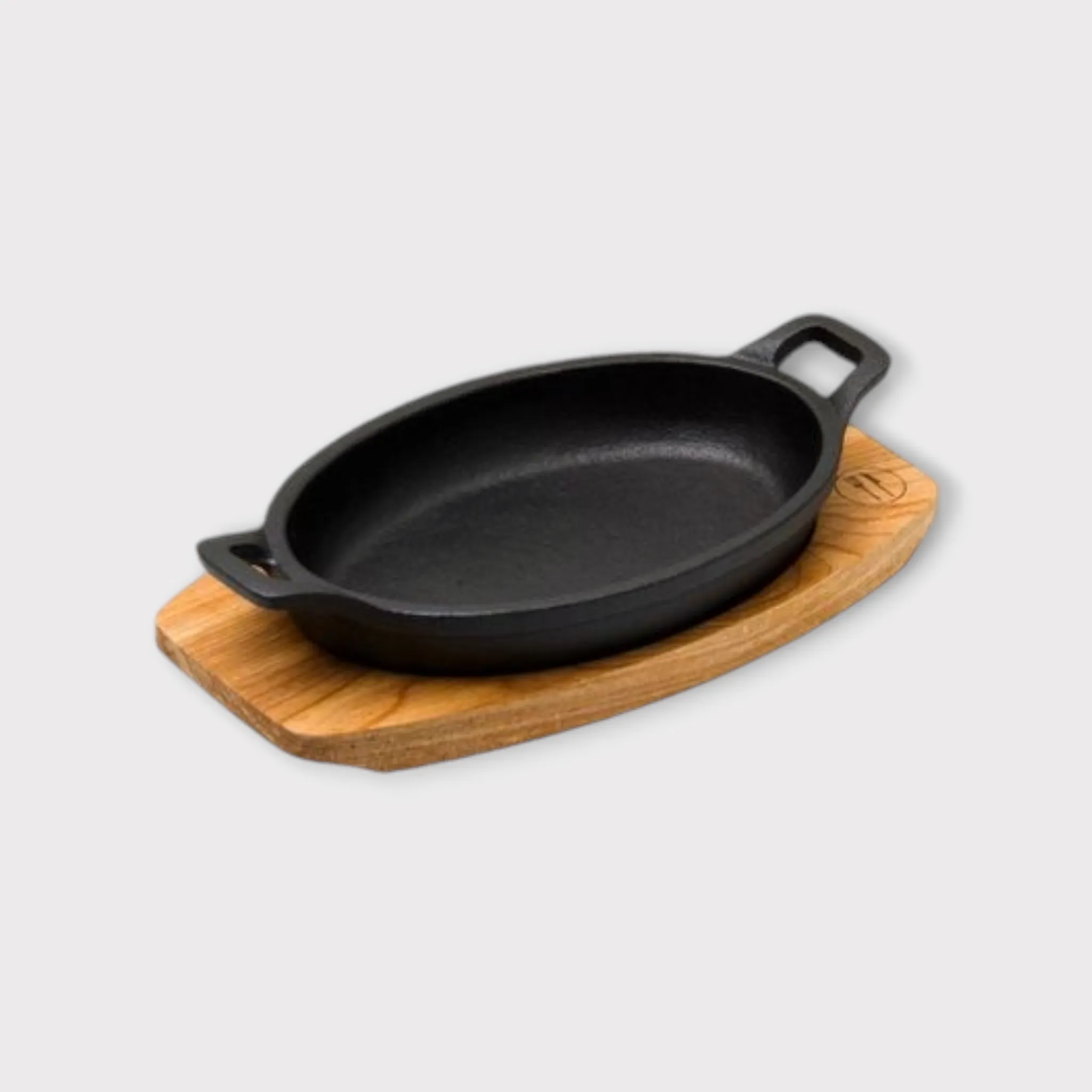 Regent Cookware Cast Iron Oval Pan with 2-Handles on Birchwood Board 30920